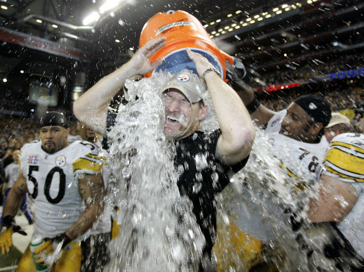 Pittsburgh Steelers head coach Bill Cowher is doused with water after his team won the Super Bowl at Ford Field in Detroit.