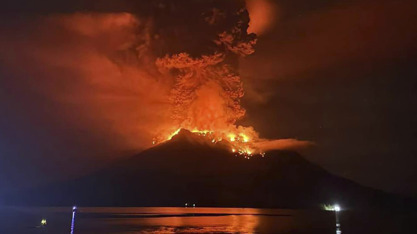 Indonesians leave homes near erupting volcano and airport closes due to ash danger