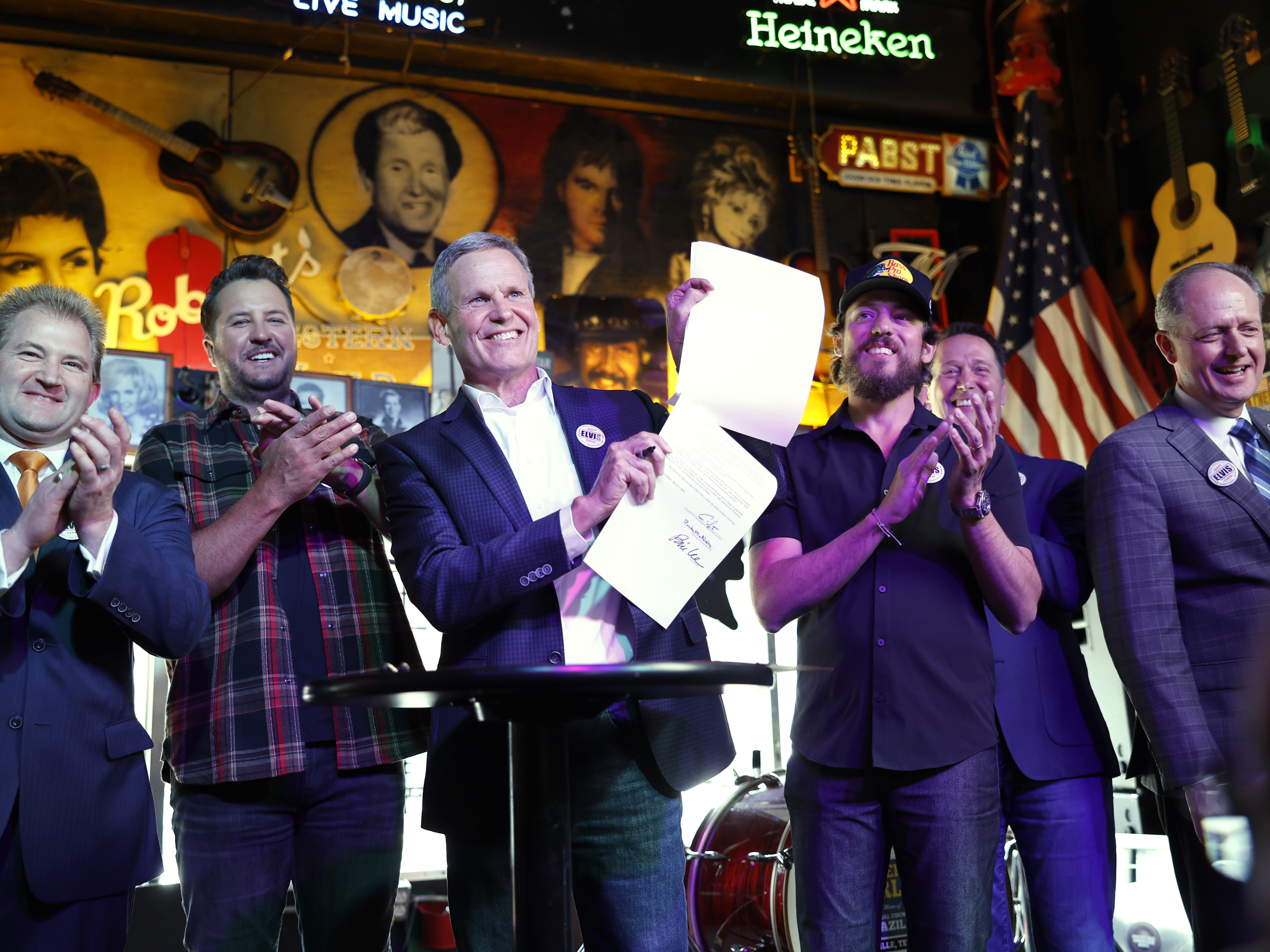 AI music isn't going away. Here are 4 big questions about what's next 1 Lawmakers and supporters pose at the signing of the ELVIS Act at Robert's Western World in Nashville on March 21, 2024. Left to right: Representative William Lamberth, musician Luke Bryan, Governor Bill Lee, musician Chris Janson, RIAA head Mitch Glazier and Senator Jack Johnson.