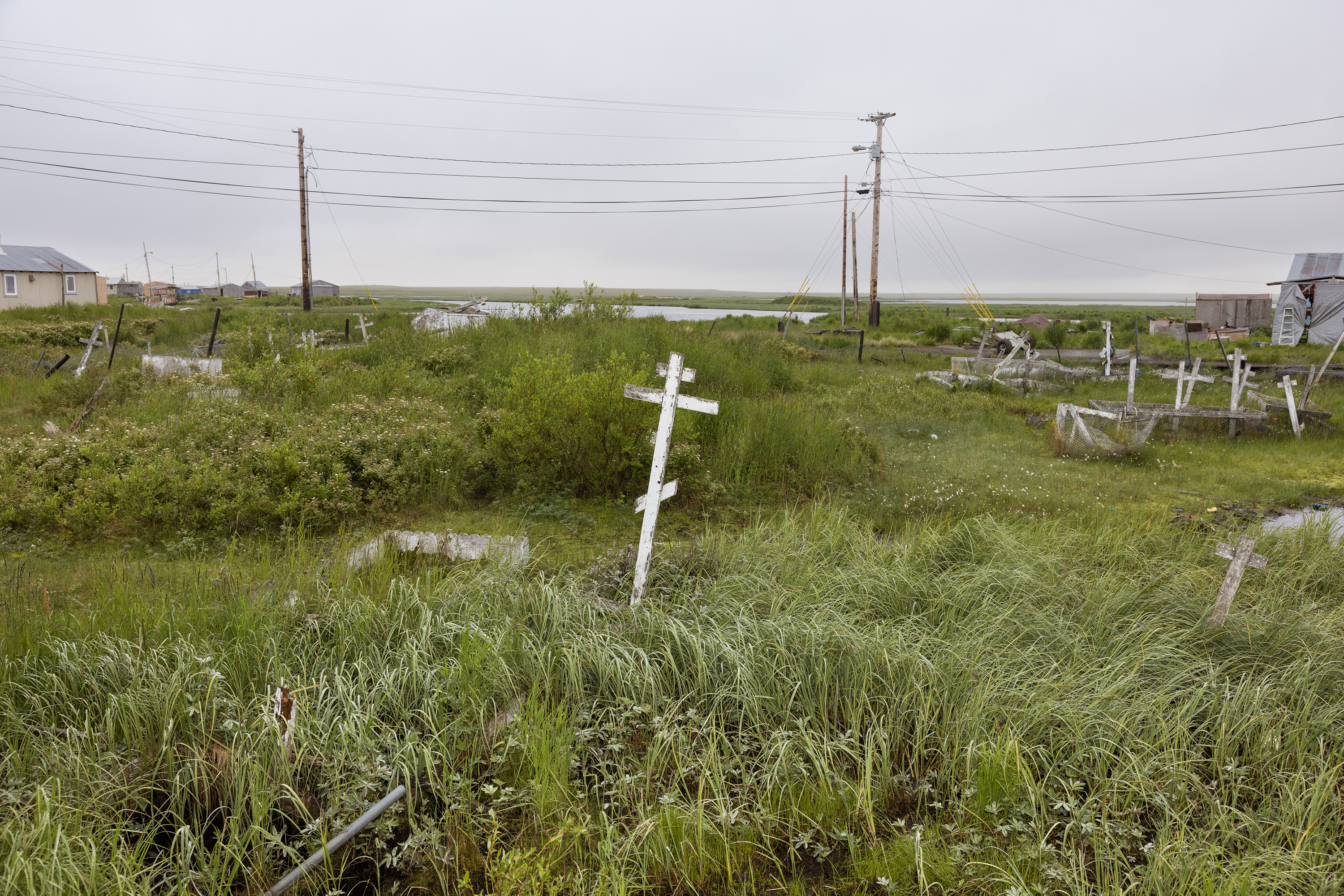 The cemetery in Akiuk is no longer safe to walk in or maintain due to sinkholes and unstable ground. The community now lays its members to rest in a new cemetery in Akula (right). Soon, the living will need to move across the river, too.
