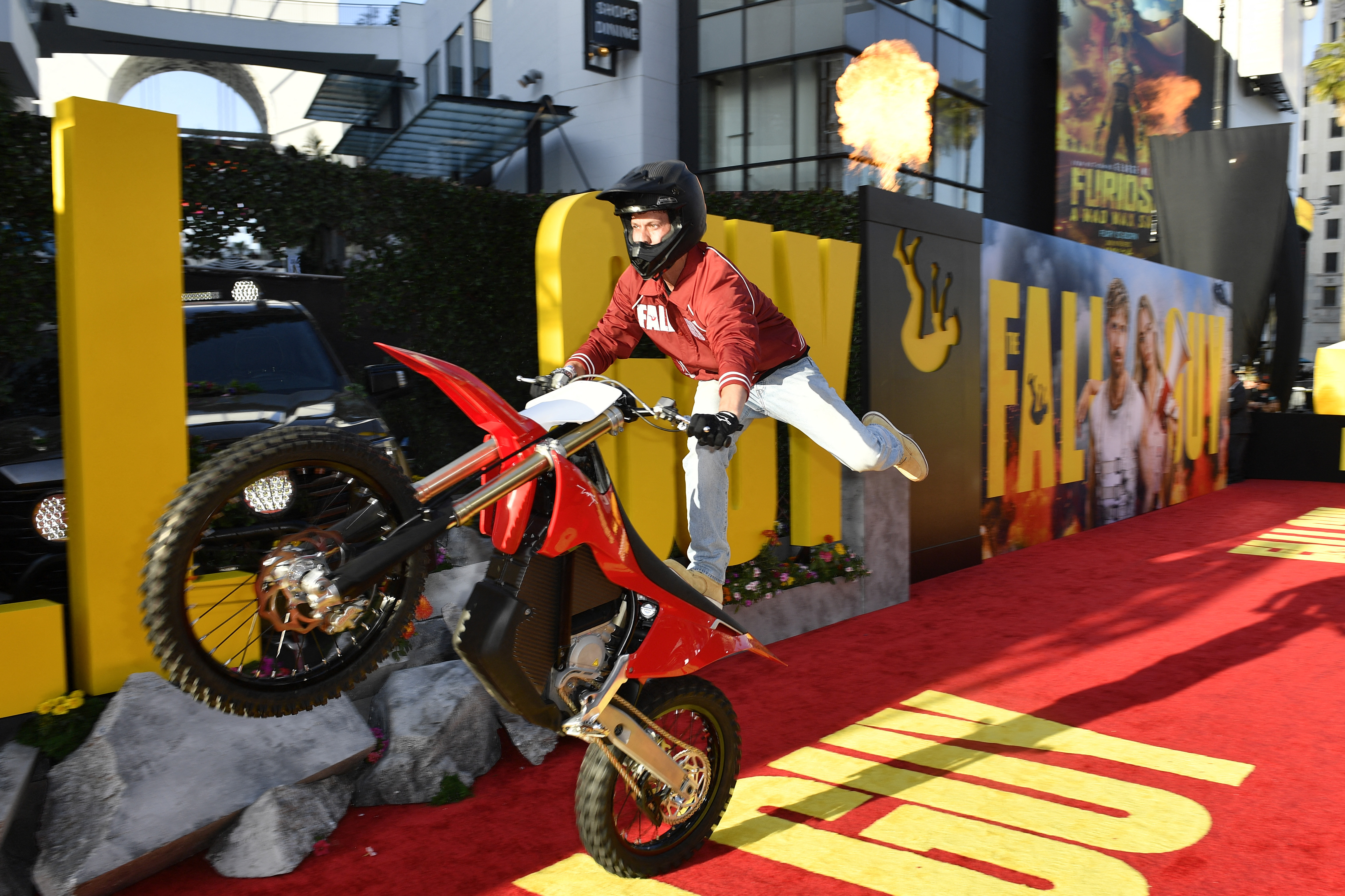 A stunt performer at the Los Angeles premiere of The Fall Guy. Outside the Dolby Theatre, another stunt artist jumped from atop a 45-foot crane, while others showed off a staged fight scene.