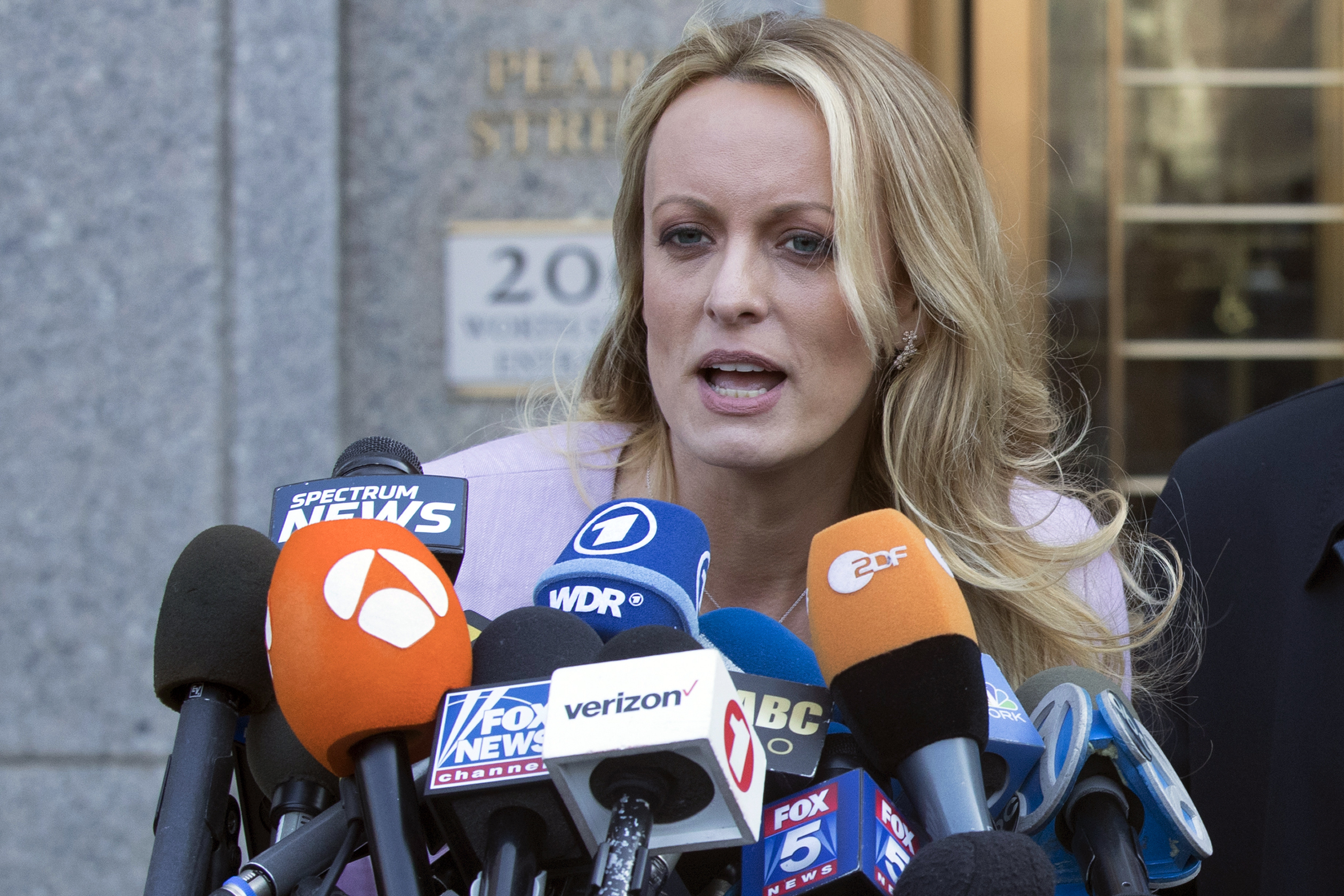Adult film actress Stormy Daniels speaks outside federal court in New York in April 2018. She is testifying this week in the criminal trial of former President Donald Trump.