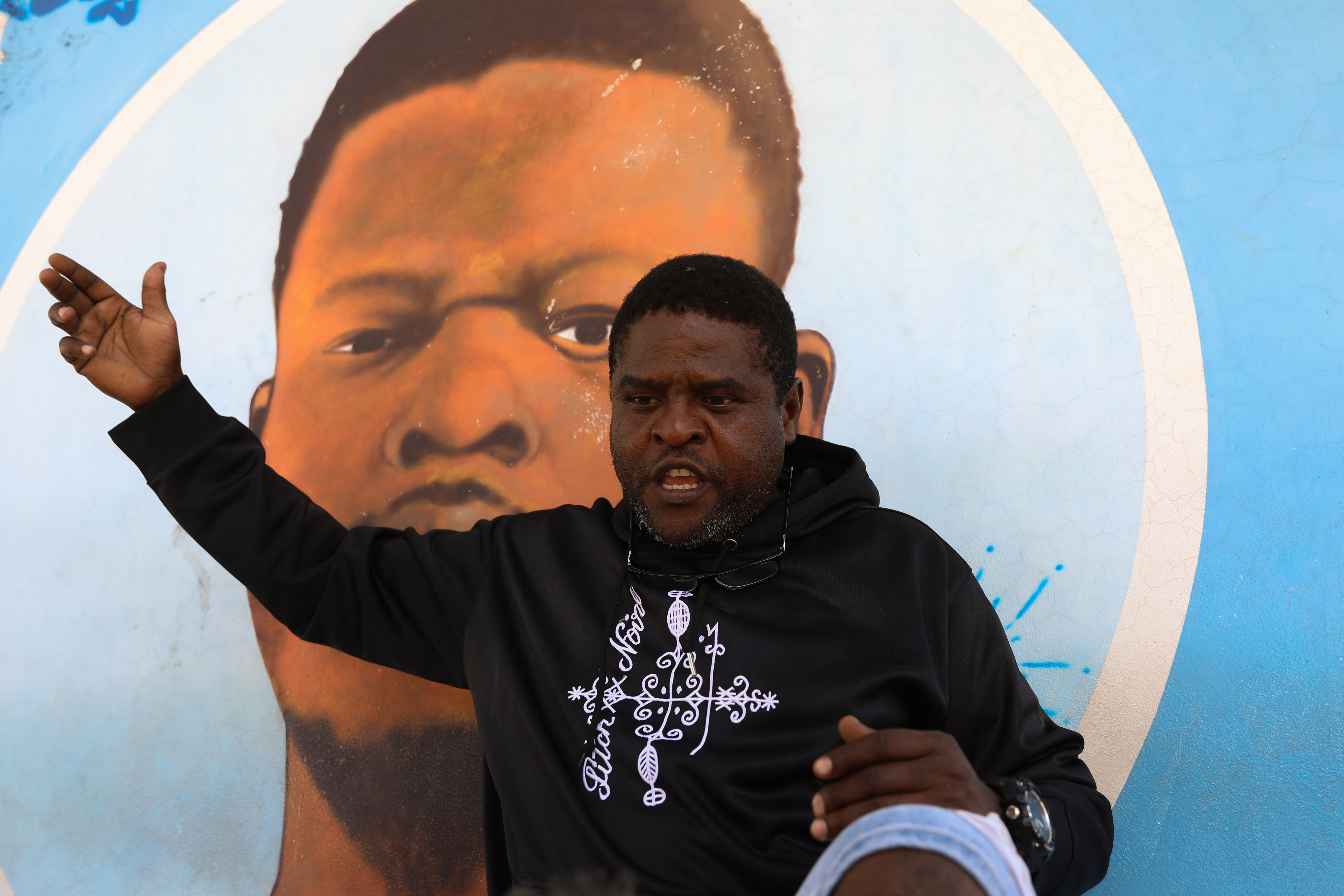 Jimmy Chérizier, a former elite police officer known as Barbecue who now runs a gang federation, speaks during an interview in Port-au-Prince, Haiti, May 11. (NPR)