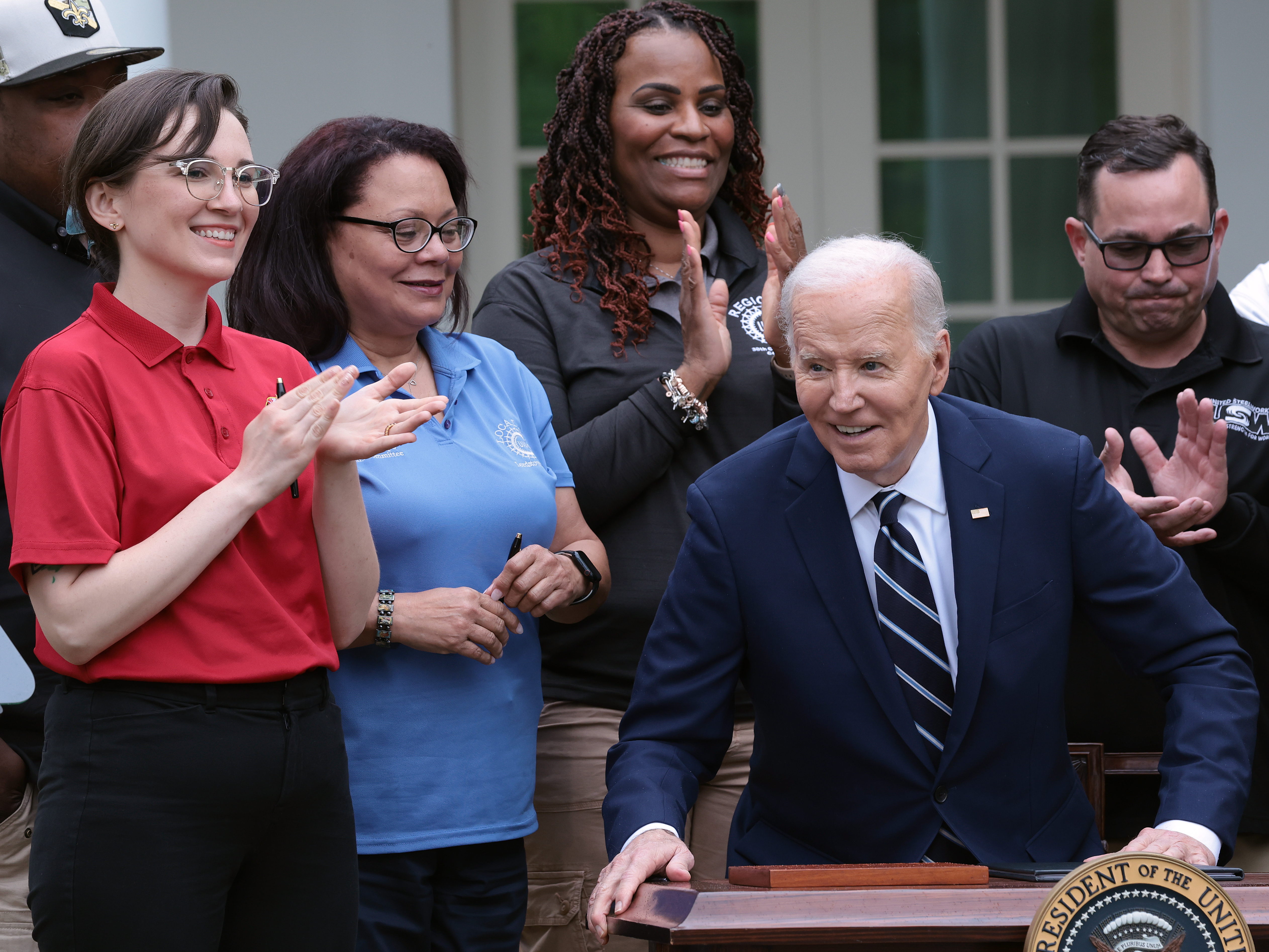 Flanked by union members, President Biden signs orders that increase tariffs on imports of electric vehicles and other strategic goods from China. (Getty Images)