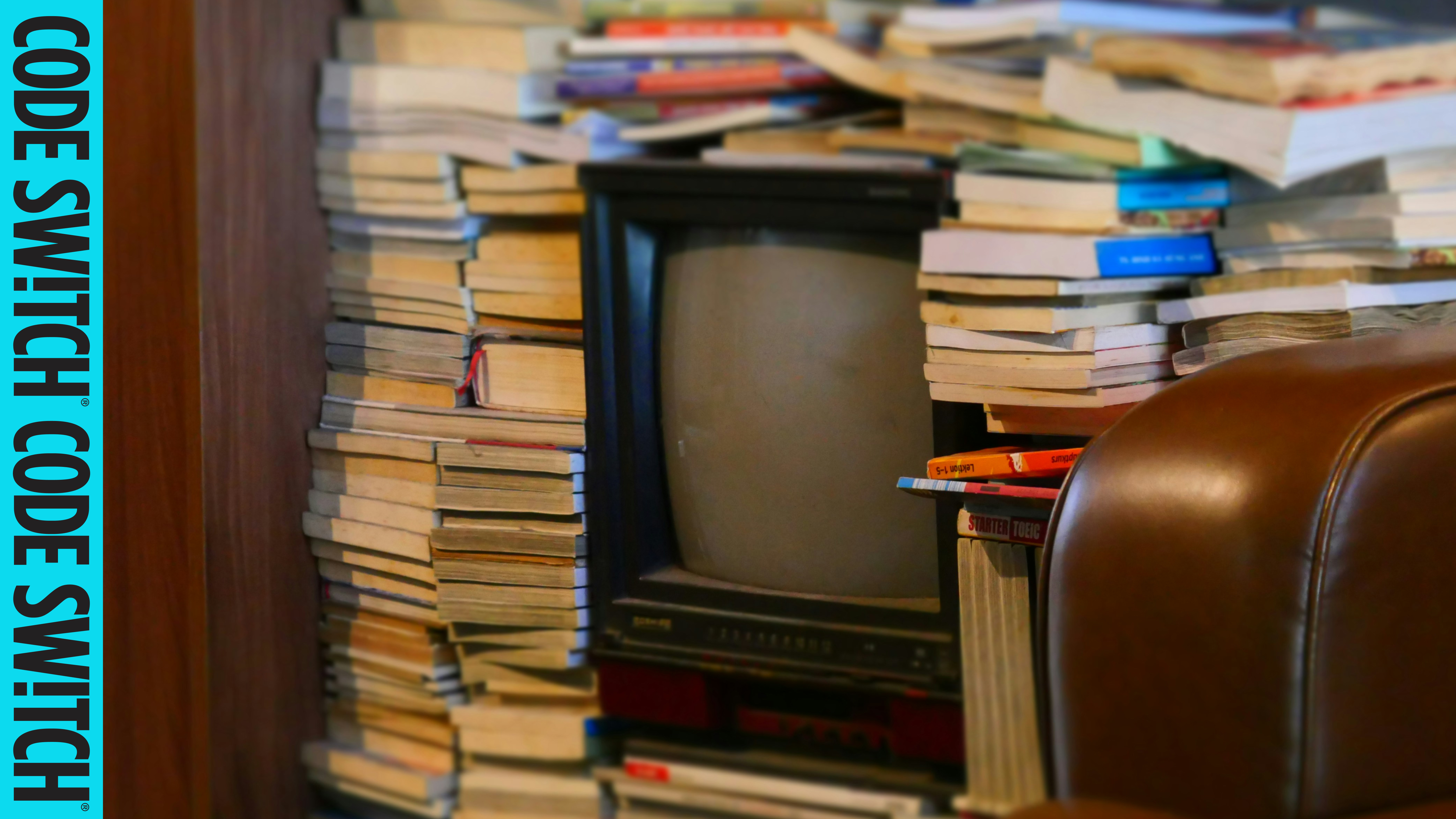 Television with books stacked up