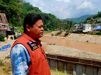 Bundit Pantarakon stands along the Sai river in Mai Sai, where the Thai Army is building flood control barriers along the river that forms the border between Thailand and Myanmar.