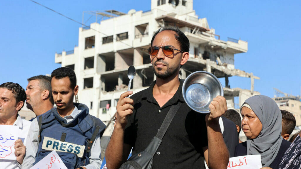 Demonstrators and journalists gather to protest against hunger in the Rimal district of Gaza City. (AFP via Getty Images)