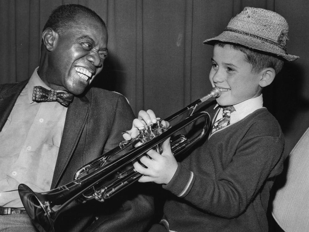 Louis Armstrong and a young fan. (Getty Images)