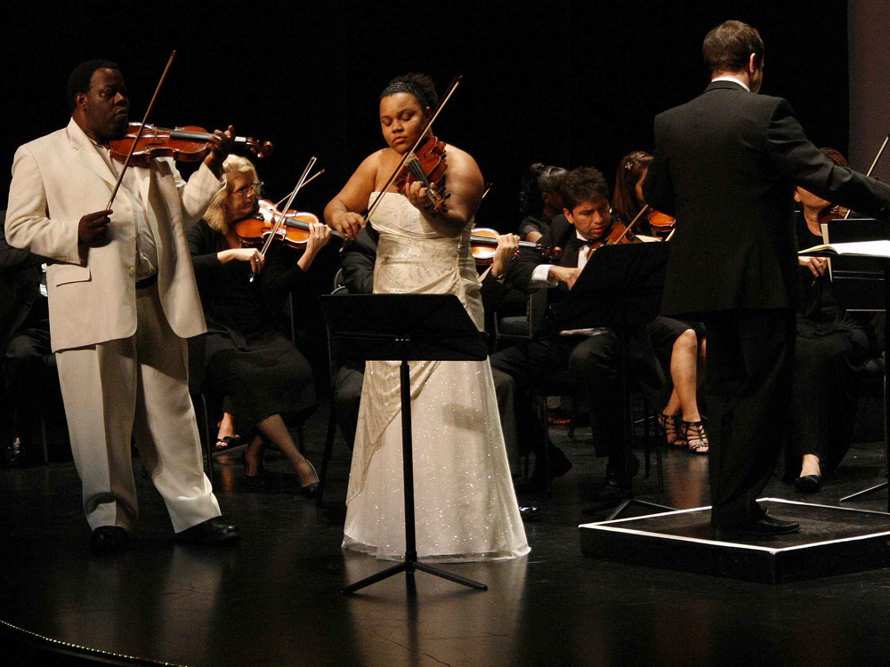 Romel Joseph, founder of The New Victorian School in Haiti, and his daughter Victoria perform at the Aventura Cultural Center in Miami on Jan. 8. It was Joseph's first performance since last year's earthquake.