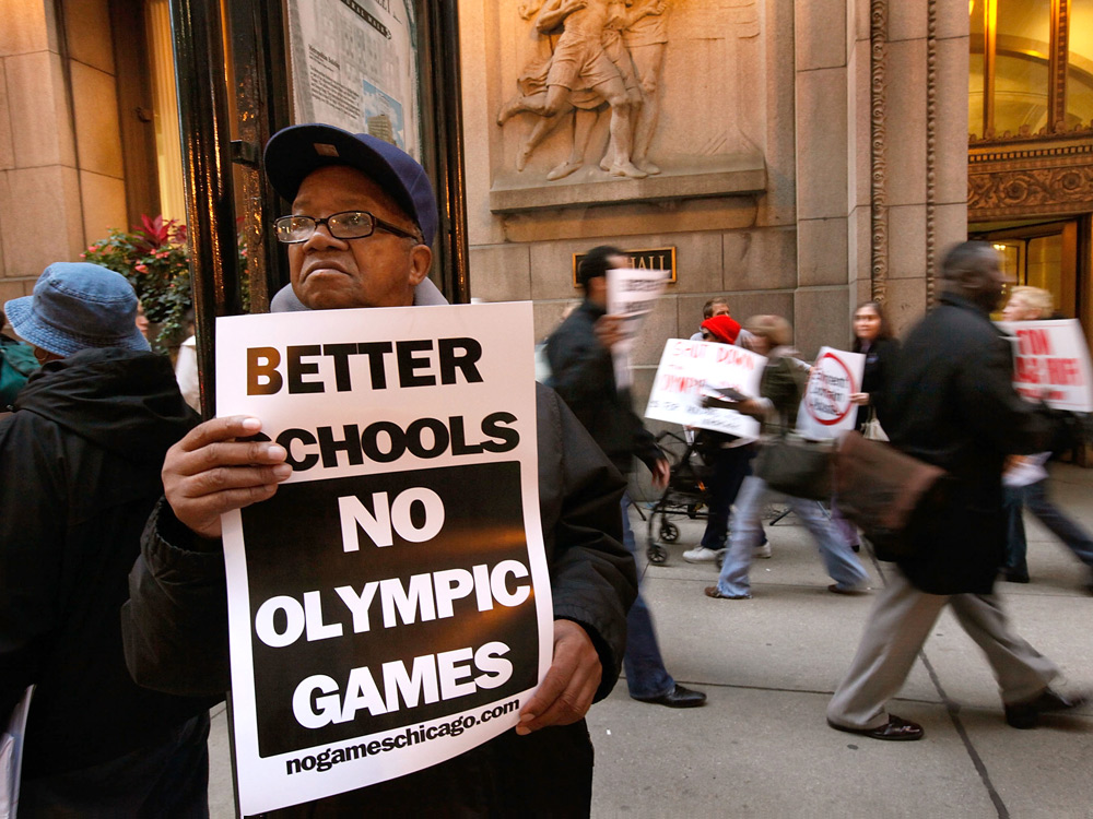 Limmie McMiller stands with demonstrators outside City Hall to protest Chicago's bid for the 2016 Olympics. The International Olympic Committee is scheduled to announce which city will host the games Friday. (Getty Images)