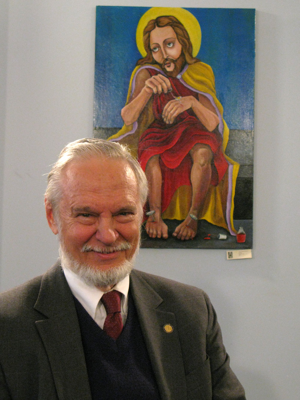 Stuart Jordan, science adviser to the Center For Inquiry, with the painting <em>Jesus Does His Nails</em> by Dana Ellyn, on display at the Center for Inquiry. Jordan says he would prefer that atheists and secularists not be associated with such artwork.