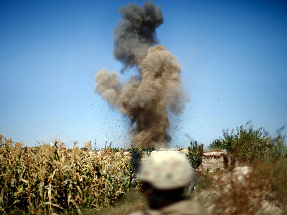 Marines from an explosive ordnance disposal team detonate a homemade explosive device, which was discovered near a compound outside of their base. (NPR)