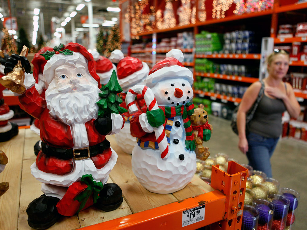 A woman walks by Christmas merchandise offered for sale in October at a Home Depot in Niles, Ill. Analysts predict the troubled economy will result in flat retail sales this holiday season. (Getty Images)