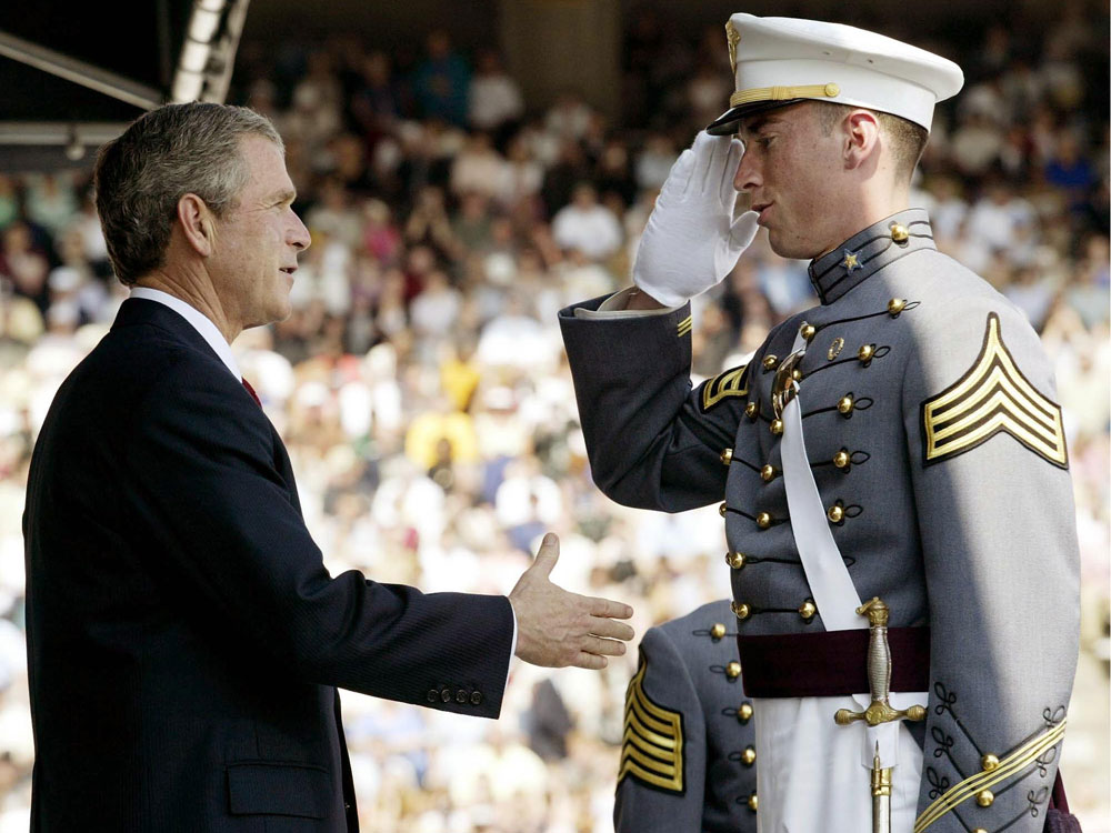President George W. Bush congratulates graduate Matthew Nethers at the commencement ceremony at the U.S. Military Academy at West Point in New York on June, 1, 2002. (AFP/Getty Images)
