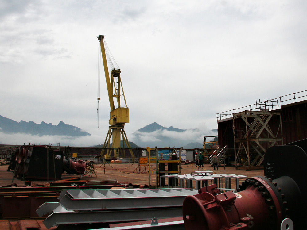 Enormous oil production platforms, incorporating approximately 50,000 tons of steel, are being built by state-owned Petrobras at this shipyard in Angra Dos Reis, Brazil. Upon completion, they will be capable of producing 180,000 barrels of crude oil per day. (NPR)