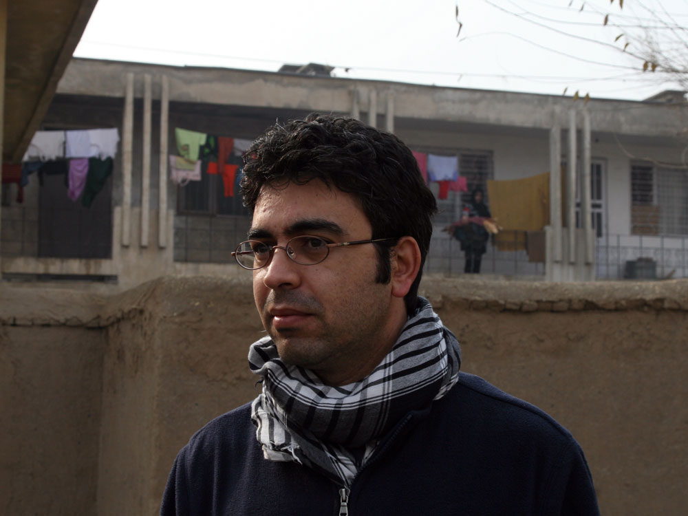 Akmal Sawi stands in front of his childhood apartment.