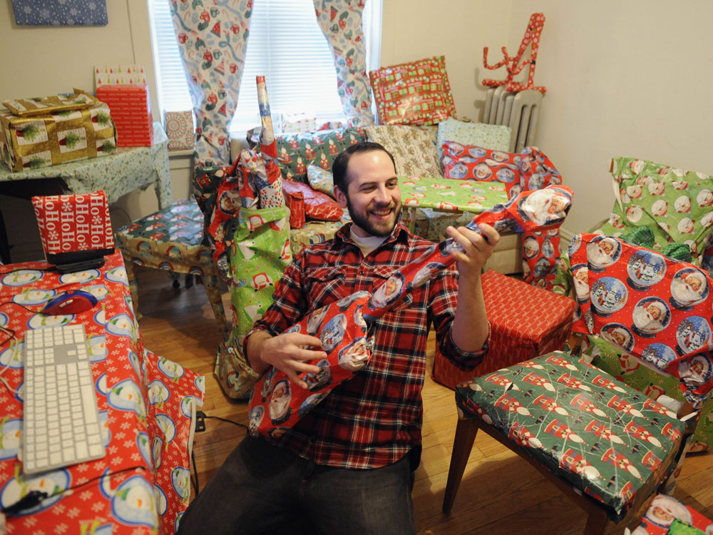Adal Rifai sits in his friend Louie Saunders' apartment in Chicago.