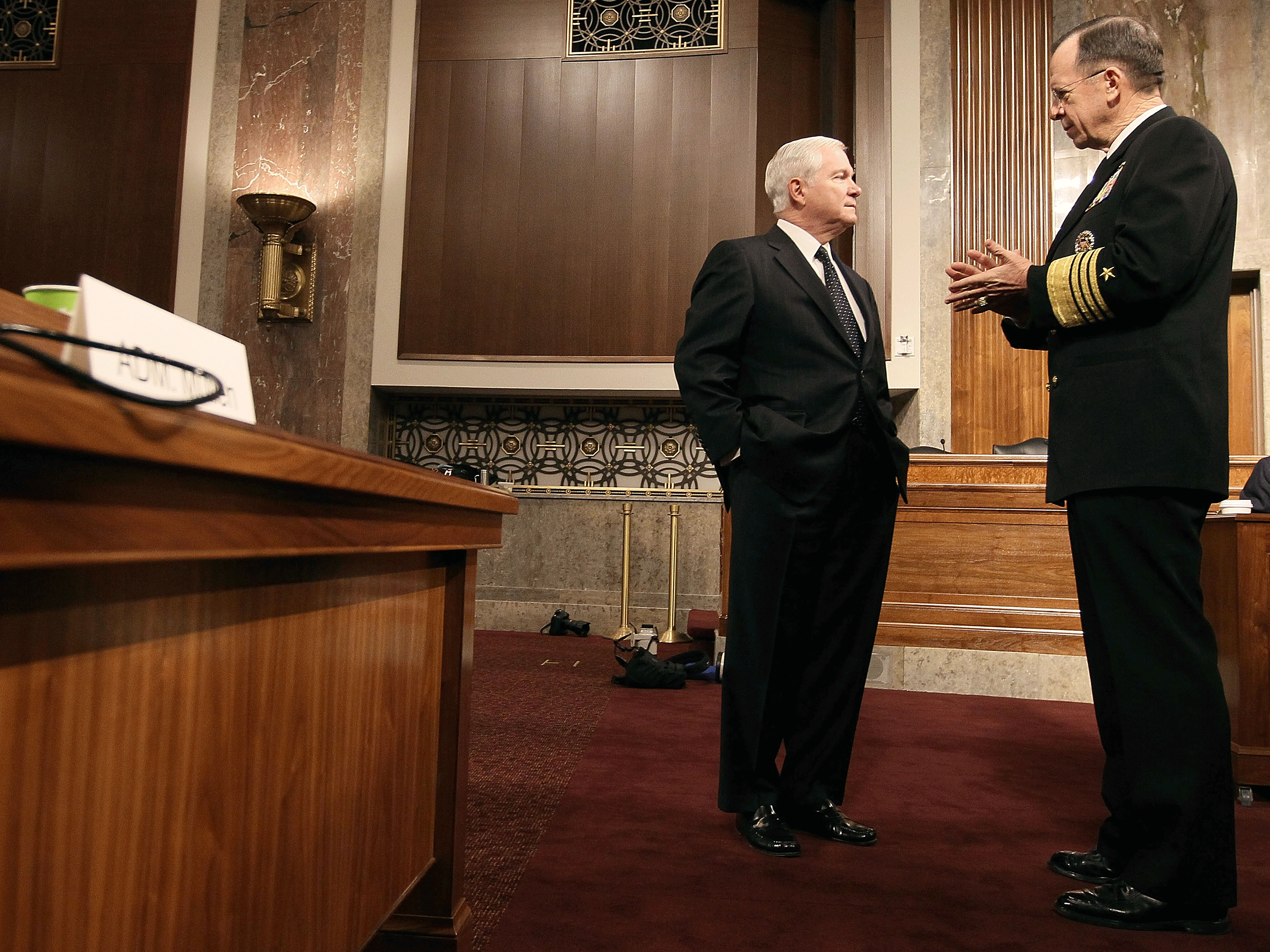 Defense Secretary Robert Gates (left) and Joint Chiefs of Staff Chairman Adm. Michael Mullen talk before the start of a Senate Armed Services Committee hearing Tuesday. (Getty Images)