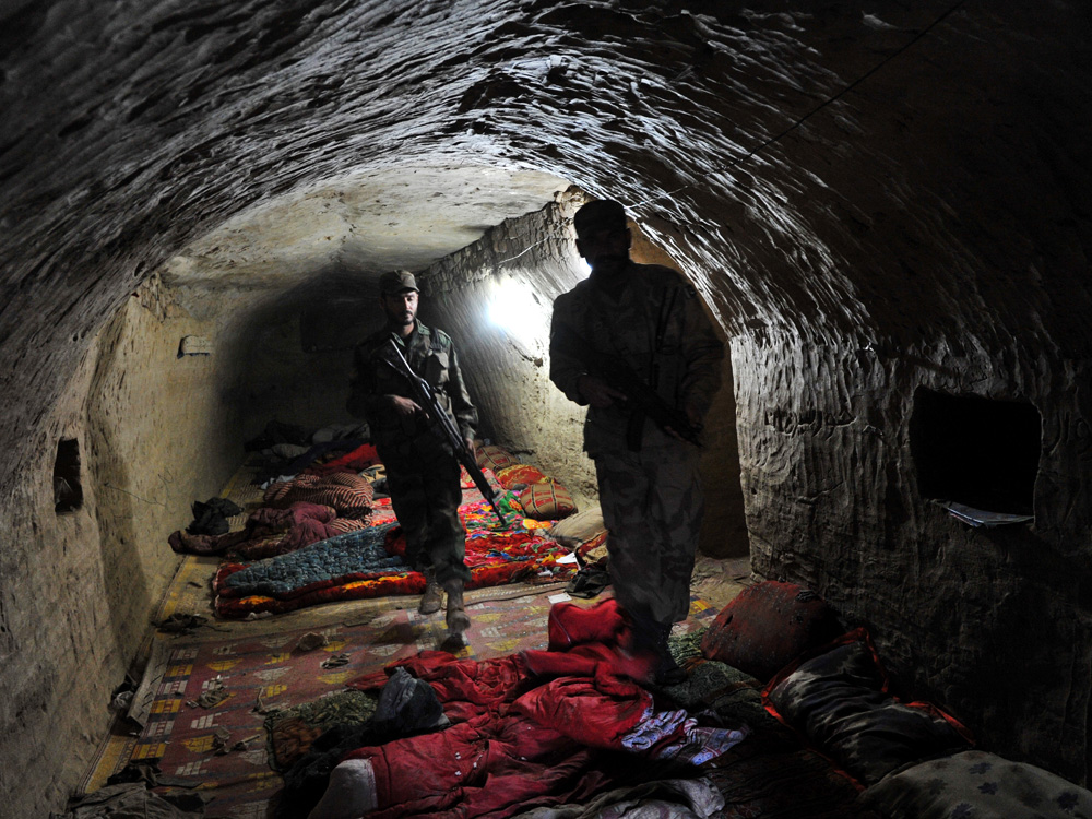 Pakistani soldiers leave a cave complex that housed a key militant headquarters in Damadola earlier this month. Pakistan's army said it had captured a key Taliban and al-Qaida complex dug into rocky mountains near the Afghan border after killing 75 local and foreign militants. A recent crackdown on Afghan Taliban leadership has disrupted the group's operations, analysts say. (AFP/Getty Images)