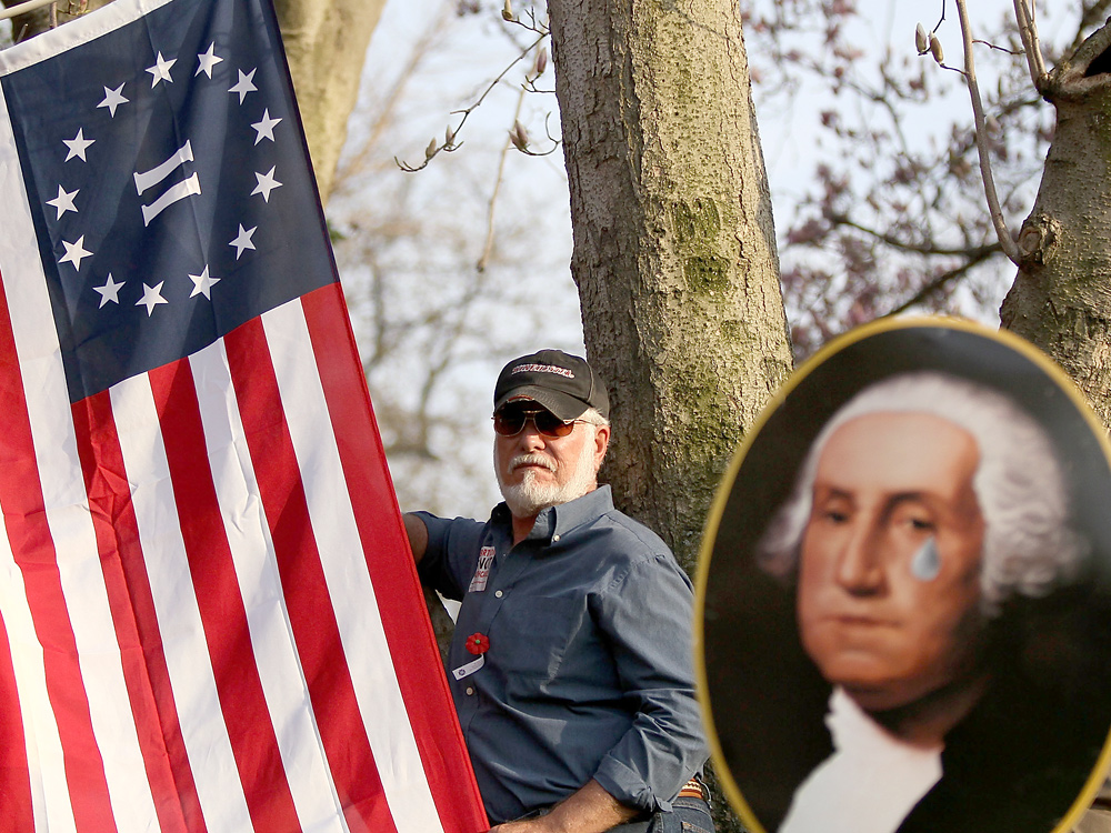 Carl Seymour of Florida was among those protesting the new health care bill this weekend. Florida is one of 12 states already planning a lawsuit to challenge  the federal legislation, saying it undermines states' authority. (Getty Images)