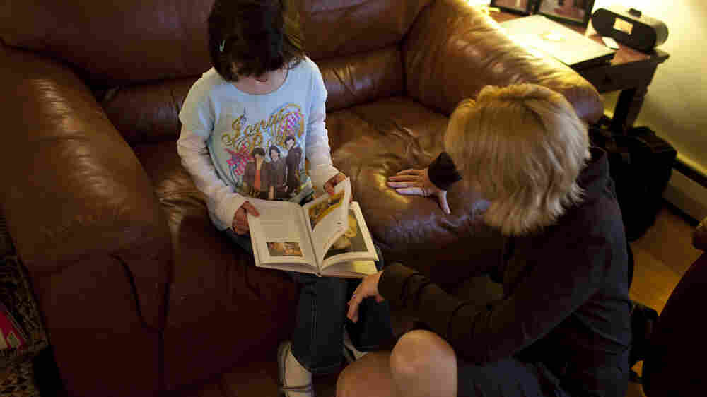 Isabelle reads a book with her mom