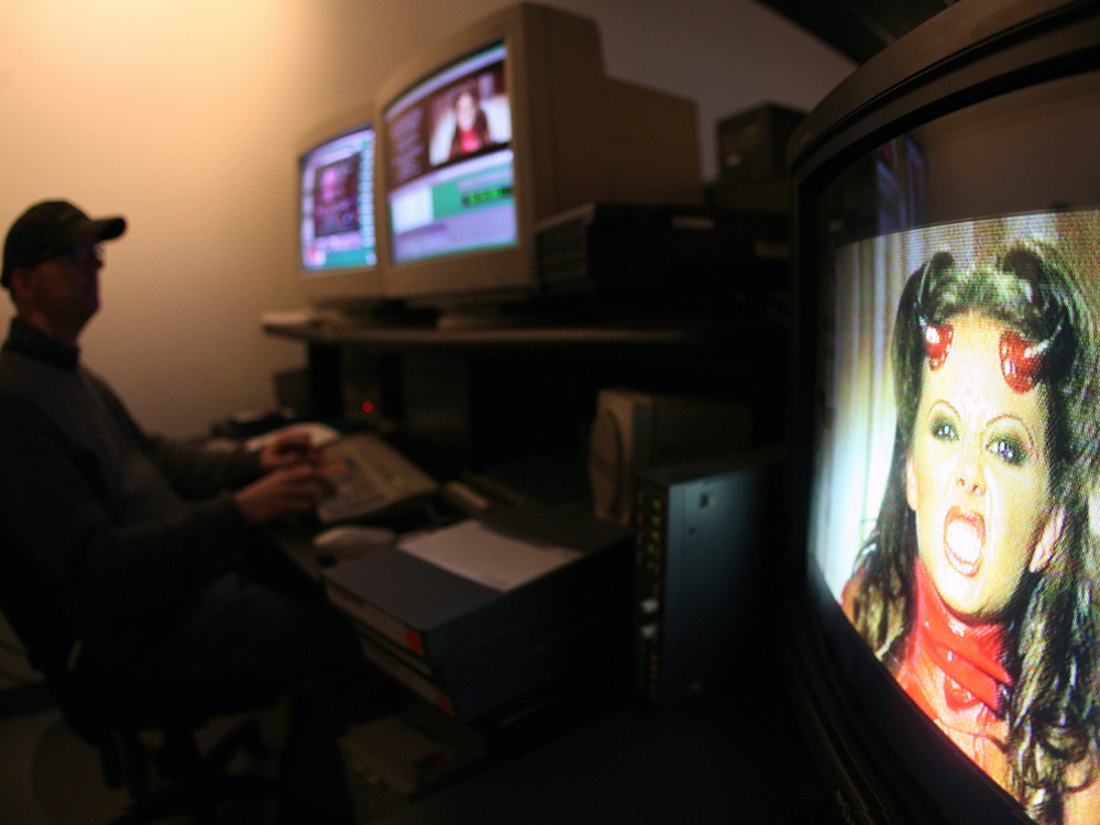 As this photo shows, costumes are often a part of pornographic films. But production studios like Vivid Video, where this movie was being edited, are resisting another piece of wardrobe: condoms. (AFP/Getty Images)