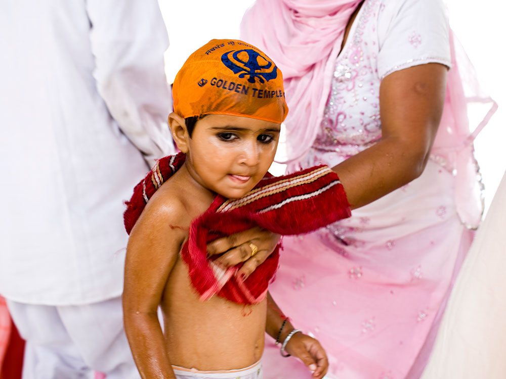 A child is toweled dry at the Golden Temple.