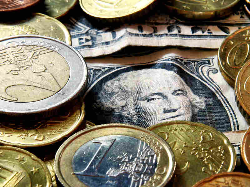 Euro coins and dollar bills
