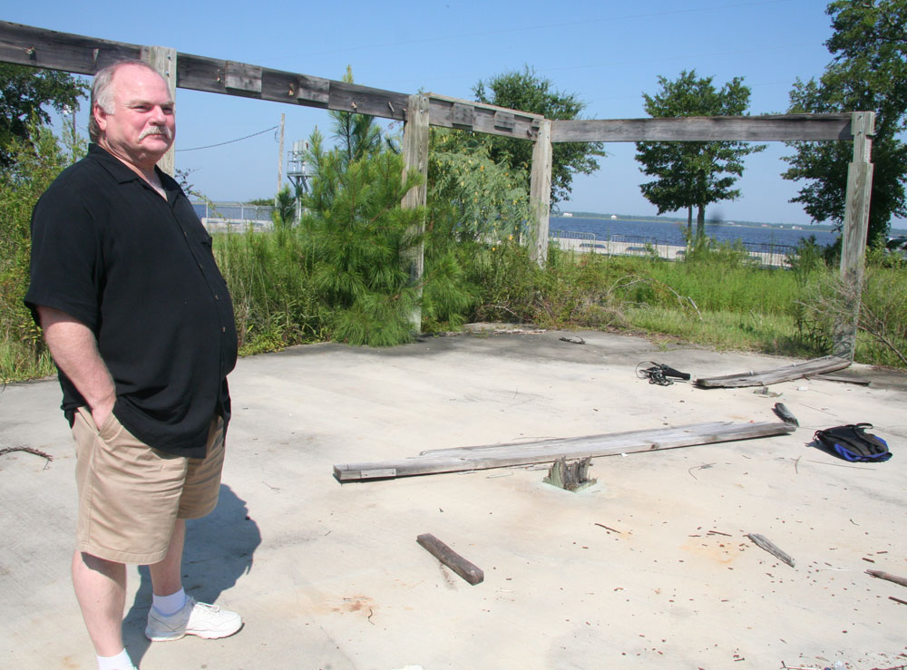 Former Bay St. Louis Mayor Edward Favre's family home was destroyed by Hurricane Katrina. All that remains now is a scarred cement slab, growing a beard of grass and vines. (NPR)