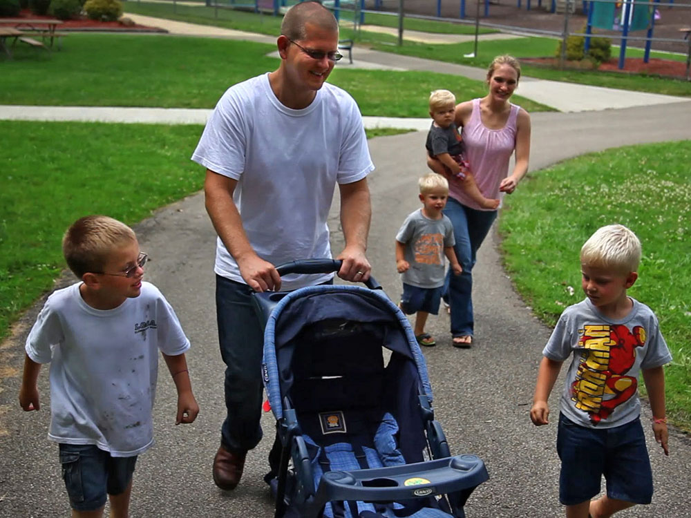 Sgt. Nathan Scheller, 29, was twice denied for a Purple Heart, though roadside bomb explosions left him with lasting cognitive damage.  &quot;I don't see how somebody else can tell me that I don't deserve one,&quot; he says.  Above, Scheller walks with his wife, Miriam, and his family. (NPR/FRONTLINE)