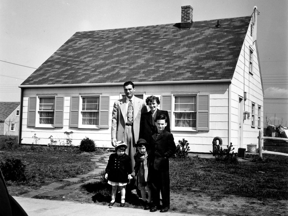 Truck supervisor Bernard Levey with his family in front of their home in the then-new Levittown, Pa., housing development in 1950. (Time Life/Getty Images)