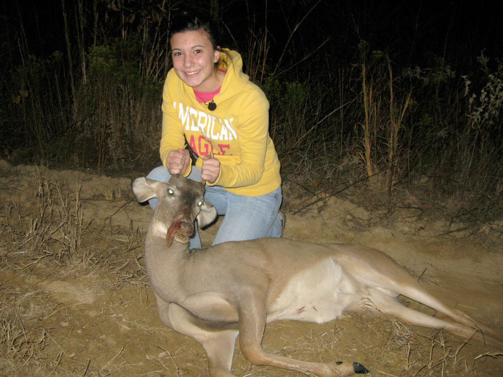 Magan Hebert, 15, poses with the young buck, or "spike," that she shot in Waynesboro, Miss., in November. Magan has been hunting since she was  in the fourth grade. (NPR)