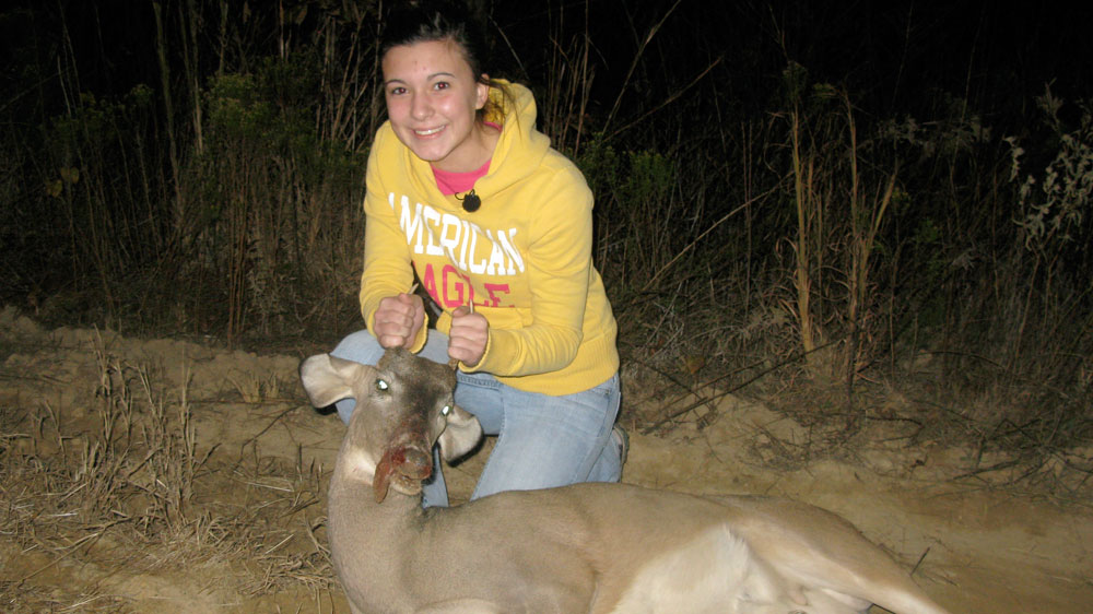 Magan Hebert, 15, poses with the young buck, or "spike," that she shot in Waynesboro, Miss., in November. Magan has been hunting since she was  in the fourth grade. (NPR)