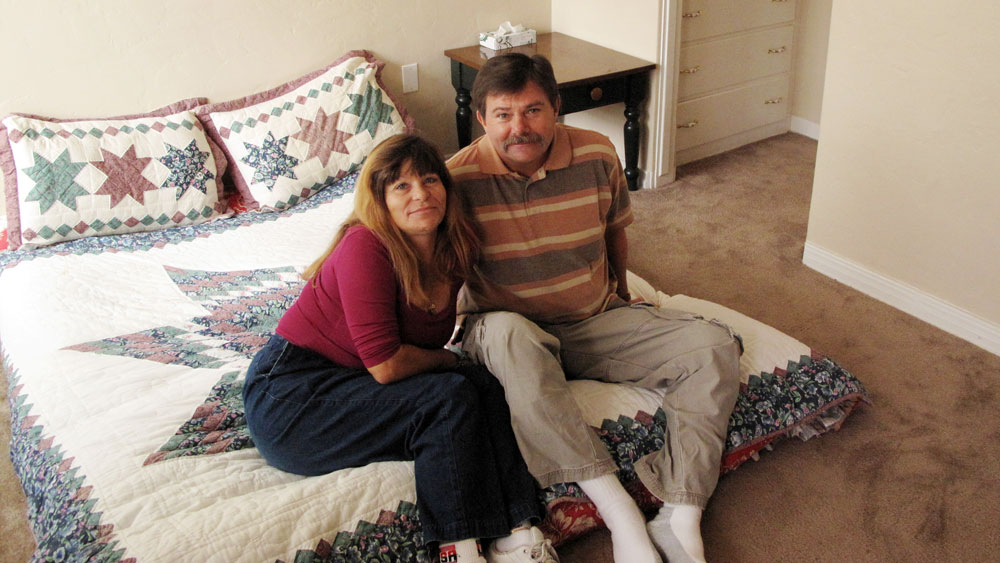 Philip Doud and  his girlfriend, Cathy Espong, sit in their new one-bedroom apartment.  They both lost their jobs and were found living on a San Diego sidewalk  during a survey of the city's homeless population last fall. The  Department of Veterans Affairs helped move the couple into permanent  housing as part of a campaign to end homelessness. (NPR)