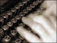 Hands typing on a typewriter.