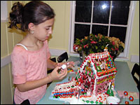 A Gingerbread House Built of Whimsy and Love 3 Donovan's children have different decorating styles. Isabel, 11, prefers perfectly symmetrical rows of carefully placed, color-coordinated candy.