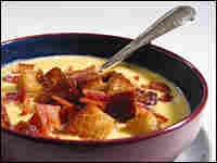 A bowl of Cheshire Chowder topped with crouton and bacon crumbles