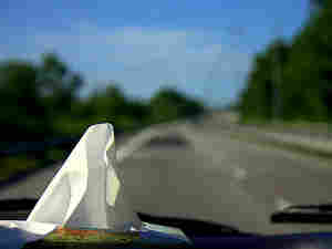 300 a box of tissues sits on a car's dashboard