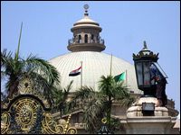 A worker (right) cleans a lamp at Cairo University on Monday. President Obama will deliver a highly anticipated address to the Muslim world there this week. (AFP/Getty Images)
