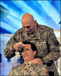 In this handout image from the USO, U.S. Gen. Ray Odierno prepares to give comedian Stephen Colbert a haircut. (USO via Getty Images)