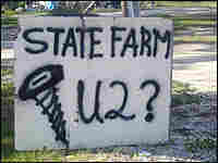 An anti-State Farm sign in a yard.