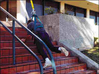A man slips on stairs sprayed with an anti-pirate slick foam