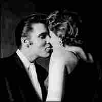 A kiss from a King: Elvis Presley and a fan share an intimate moment backstage during the 1956 tour