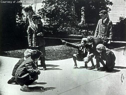 In a vision of the future, Claude and Anne's disabled child is pointed at by a group of boys playing marbles as he walks down the street with his mother.
