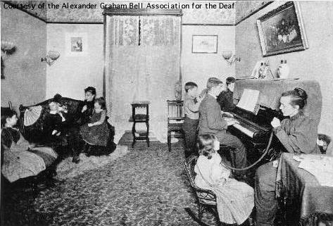 Deaf students receive 'auricular training' listening to the piano, 1893.