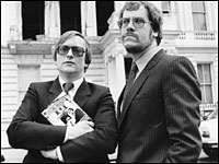 Reporter Chris Cramer, right, and fellow hostage Sim Harris co-wrote the book <em>Hostage</em> about their experience. Here, the pair are pictured in front the burnt out Iranian embassy in April 1982. (Getty Images)