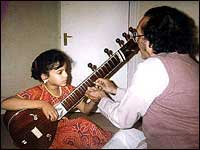 Anoushka Shankar gets sitar lessons from her father, Ravi Shankar, in 1989.