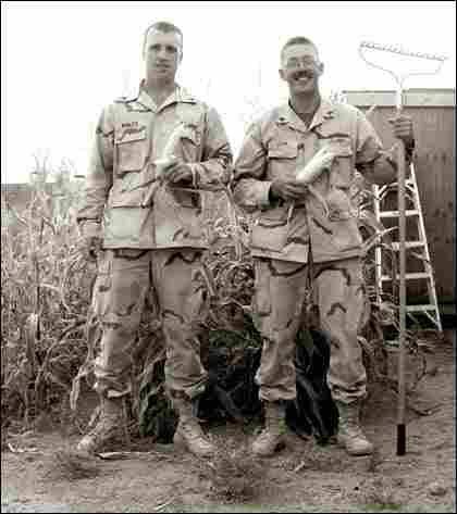 Sgts. Justin Wanzek and Carl Quam Jr. pose with their corn crop.