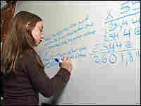 A girl works on a math problem.