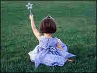 A little girl wearing a princess custome.